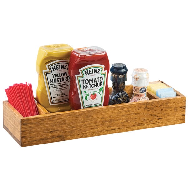 A wooden Cal-Mil Madera condiment caddy with 3 sections holding ketchup, mustard, and mustard.