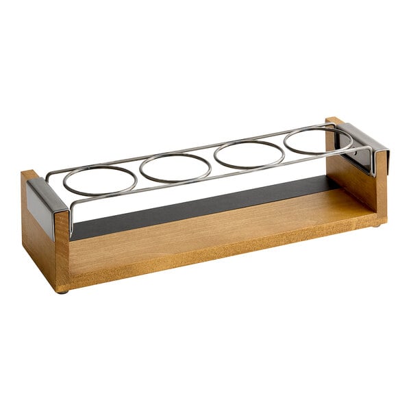 A wooden stand with metal rings holding four glasses.