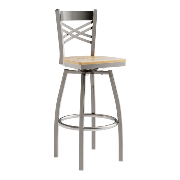 A Lancaster Table & Seating metal swivel bar stool with a driftwood seat.