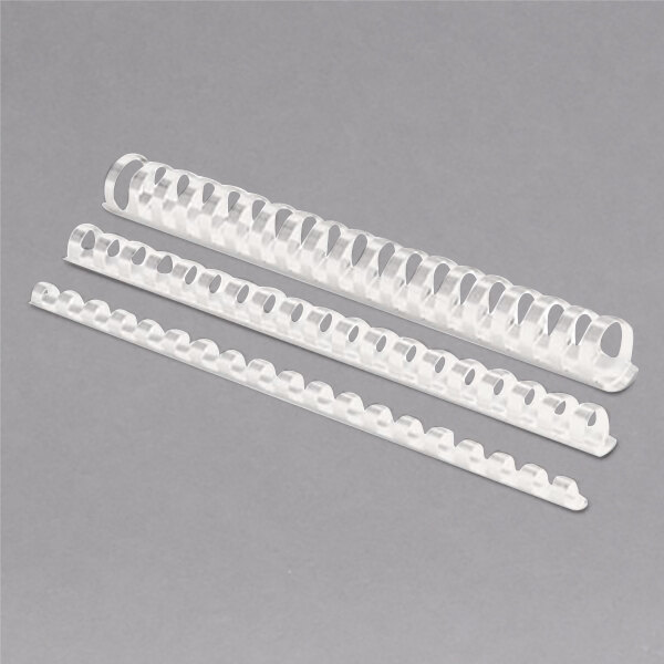 A row of white plastic binding combs on a gray surface.