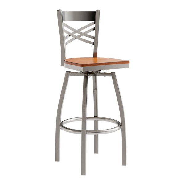 A Lancaster Table & Seating metal swivel bar stool with a wooden seat and a clear coat finish.