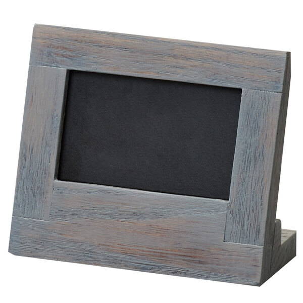 A wooden Cal-Mil Ashwood chalkboard stand.