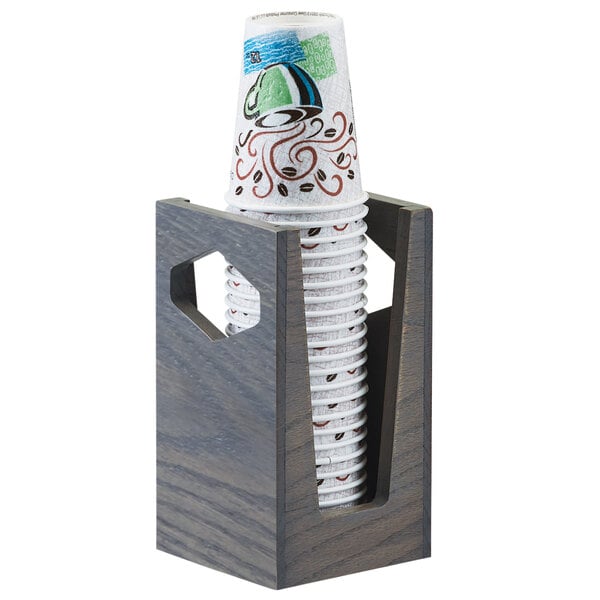 A Cal-Mil Ashwood countertop cup holder with paper cups inside.