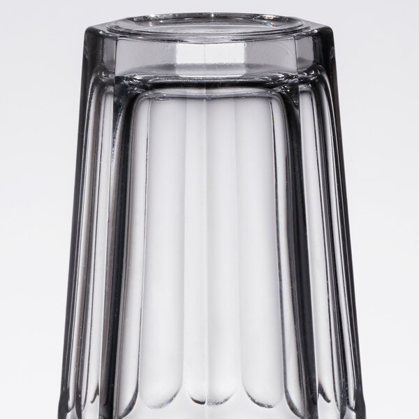 An Arcoroc clear glass with a clear base and a black rim.