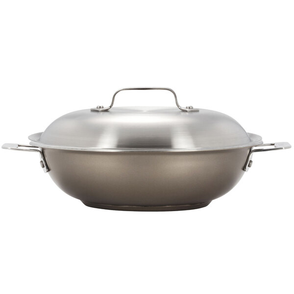 A taupe stainless steel Bon Chef brazier pan with lid.