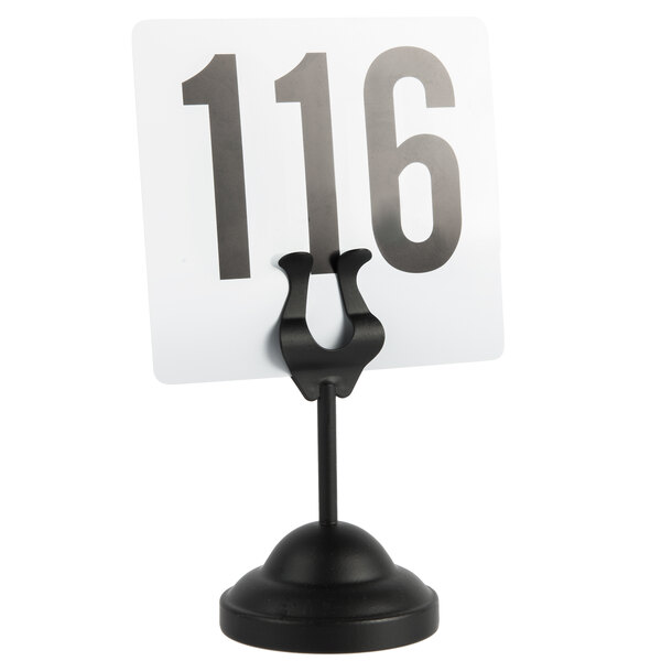 A white table card in a black American Metalcraft harp card holder on a table.