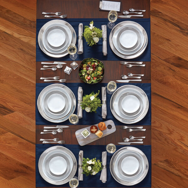 A table set with American Metalcraft Crave melamine plates and silverware.