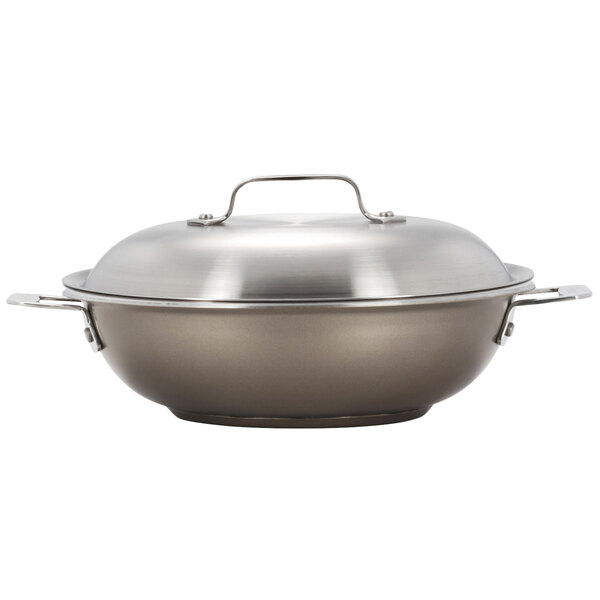 A silver stainless steel Bon Chef stir fry pan with a lid.