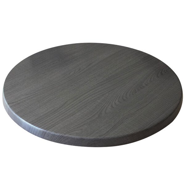 A Holland Bar Stool EnduroTop round table top in charcoal on a round wooden table.