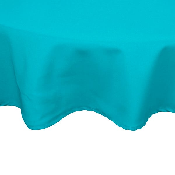 A teal Intedge 65/35 poly/cotton blend round table cover with a hemmed edge.