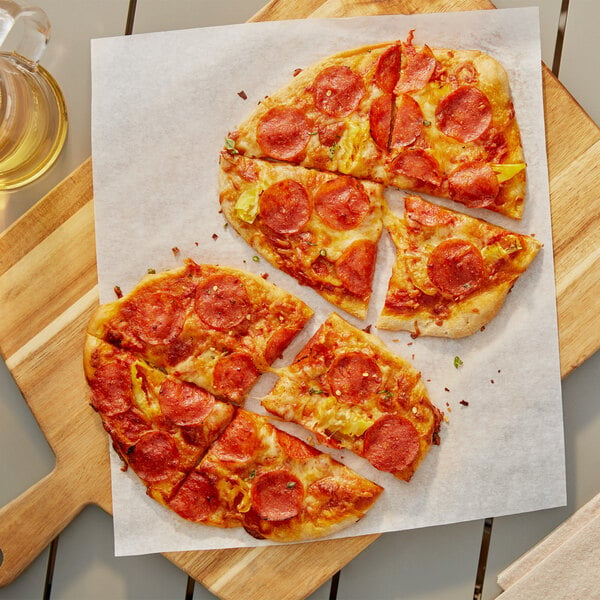 A pepperoni pizza with a slice missing on a cutting board.