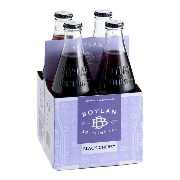 A four-pack of Boylan Bottling Co. 12 fl. oz. Black Cherry Soda bottles in a purple cardboard carrier.