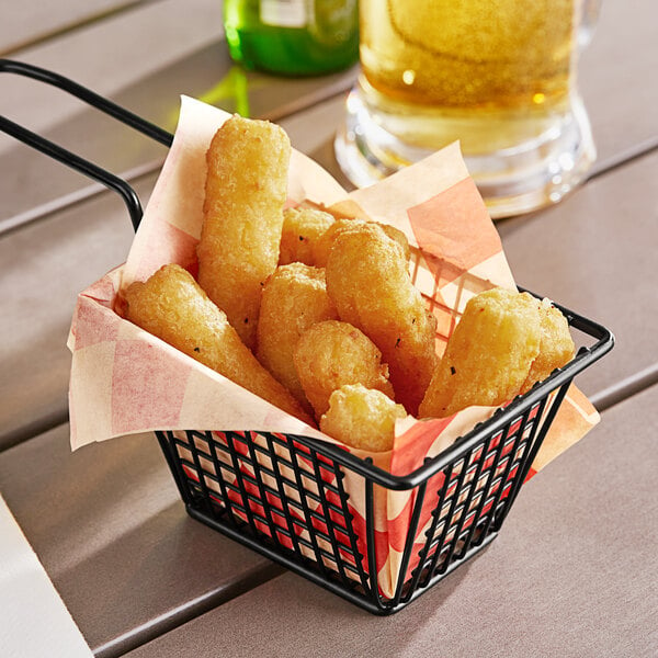 A basket of Fry Foods Premium Battered Mozzarella Sticks on a table.