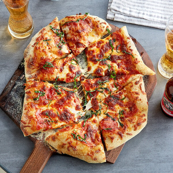 A slice of pizza with cheese and basil on a wooden board.