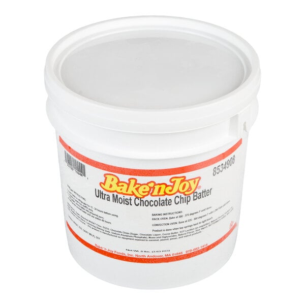 A white plastic tub with a lid labeled 'Bake'n Joy Ultra Moist Chocolate Chip Batter.'