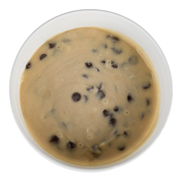 A bowl filled with light brown batter containing visible chocolate chips.