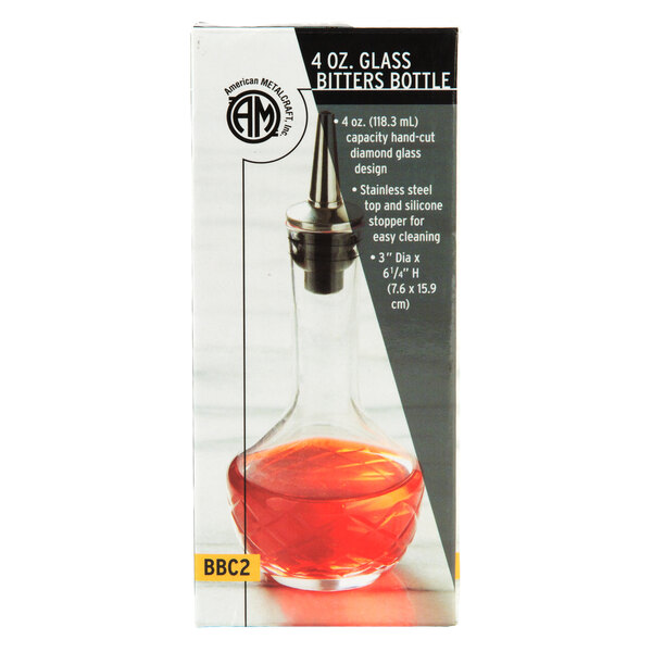 An American Metalcraft diamond glass bitters bottle filled with red liquid.