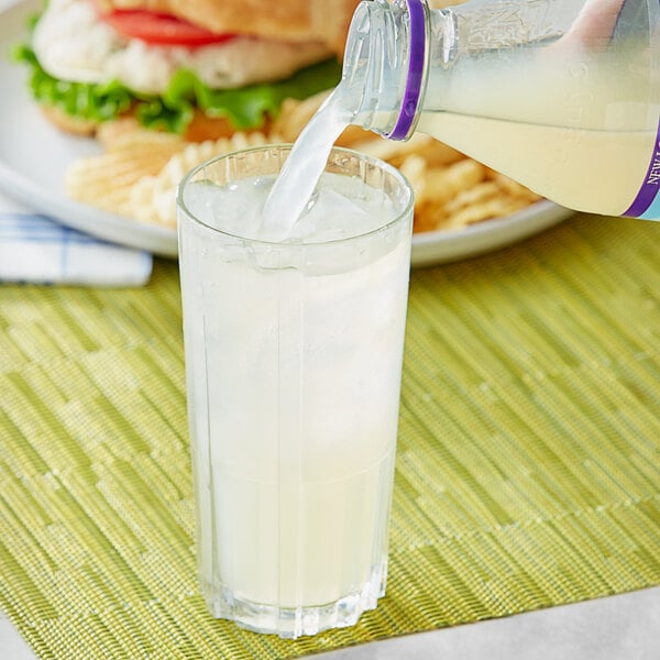 A person pouring Nantucket Nectars Squeezed Lemonade into a glass.