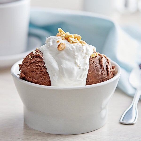 A bowl of brown ice cream topped with nuts and J. Hungerford Smith marshmallow concentrate.