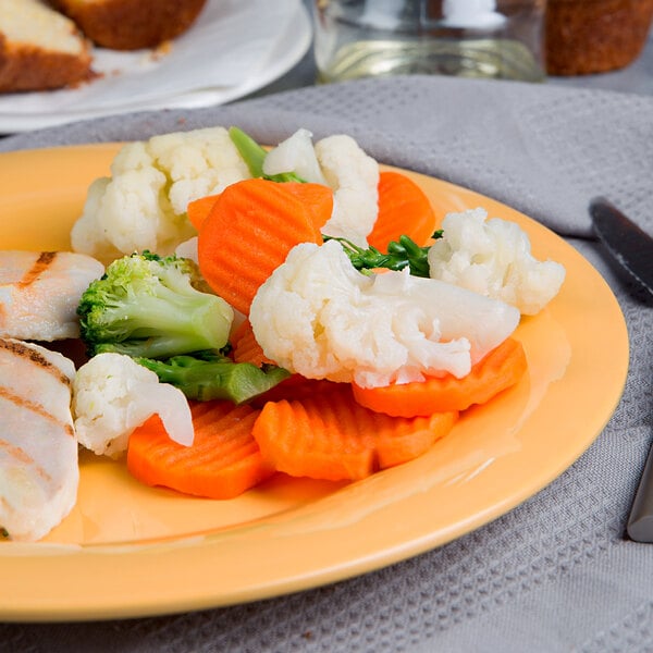 A plate of food with a close up of a vegetable blend including broccoli, carrots, and other vegetables.