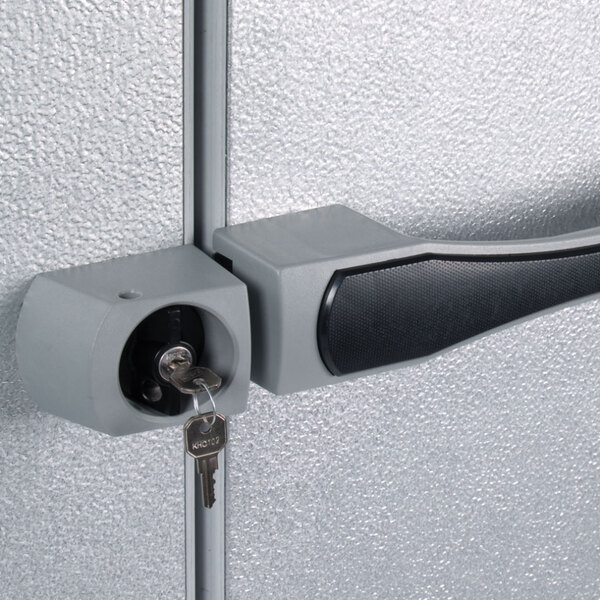 The right hinged metal door of a Kolpak walk-in freezer with a black handle.