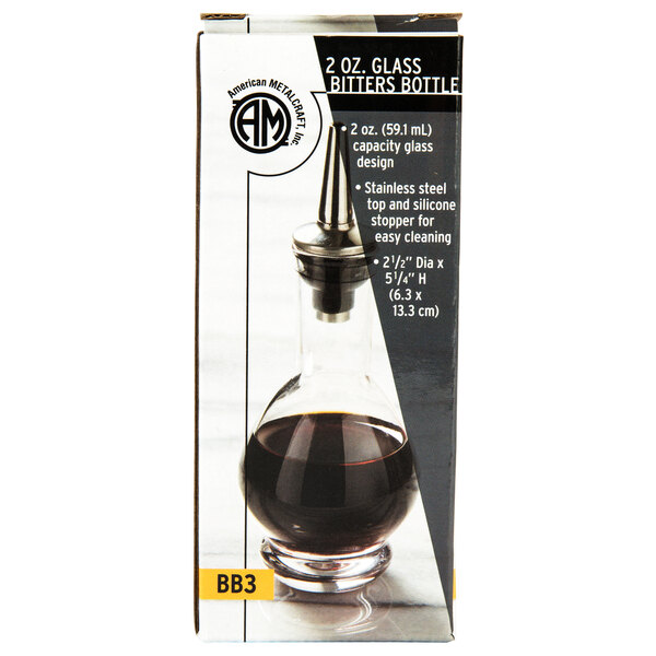 An American Metalcraft clear glass bitters bottle filled with liquid.