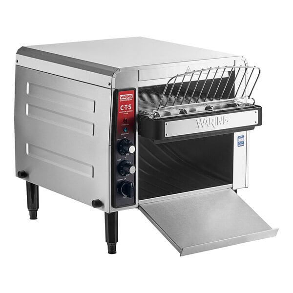 A silver Waring commercial conveyor toaster with a door open.