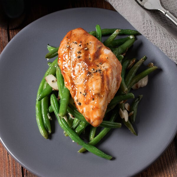 cooked chicken breast on grey plate with green beans