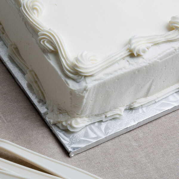 A white square cake on a silver Enjay cake drum.