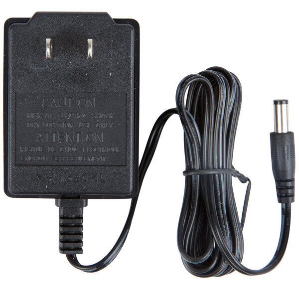 A white Taylor AC adapter with a black cord.
