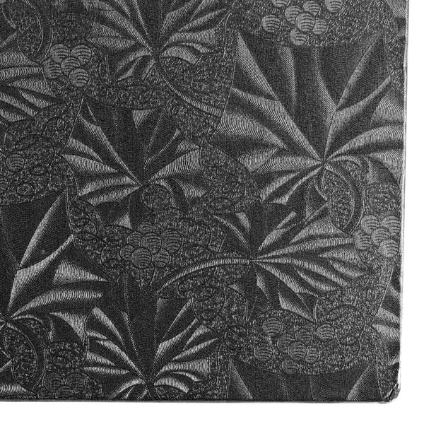 A black fabric covered in white leaves with a black and white pattern.