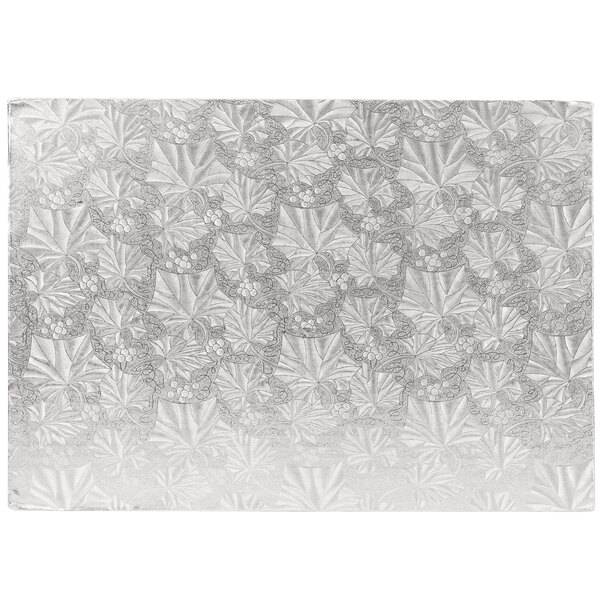 A white rectangular Enjay silver cake board with leaves on it.