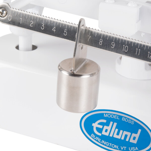 An Edlund baker's dough scale with stainless steel platters and a beam with poise.