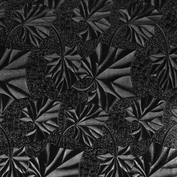 A black patterned surface on an Enjay black square cake drum.