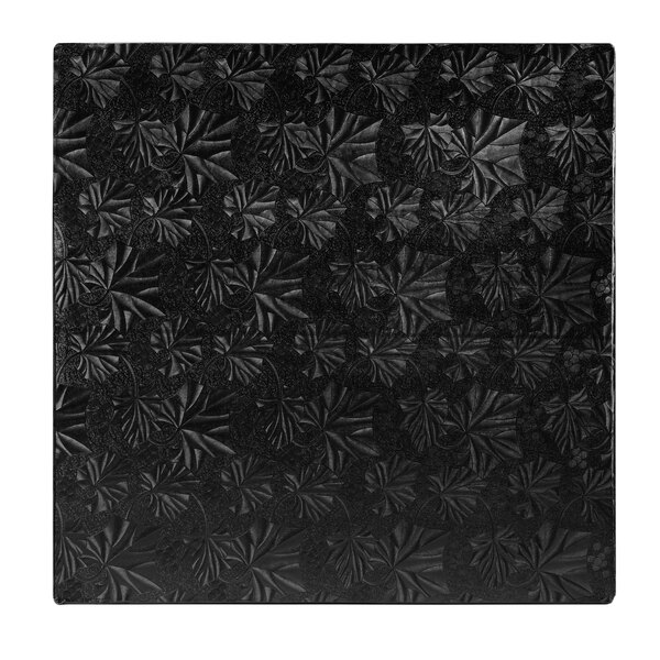 A white background with a black square Enjay cake drum with a pattern.