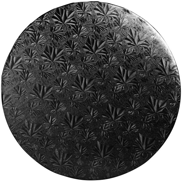 A black circular Enjay cake drum with leaf designs.