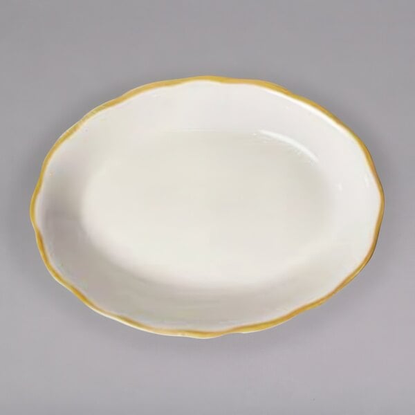 A white CAC china platter with a scalloped edge and gold trim.