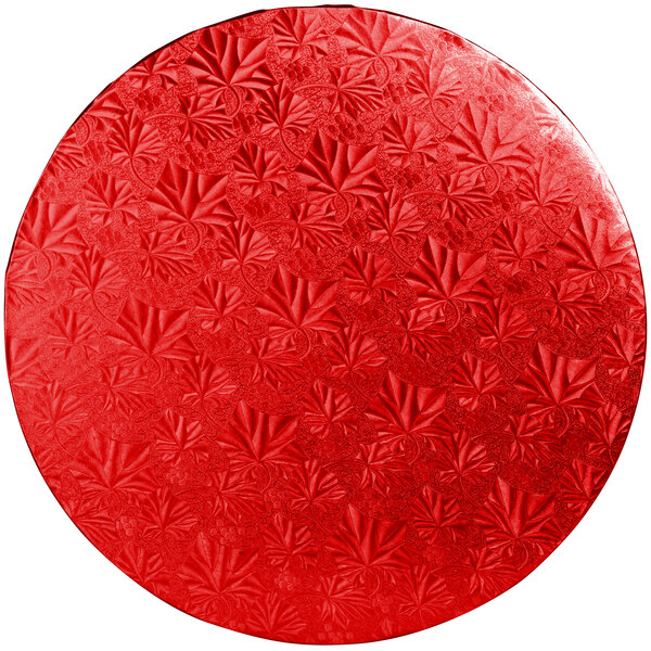A red round Enjay cake drum with a leaf pattern.