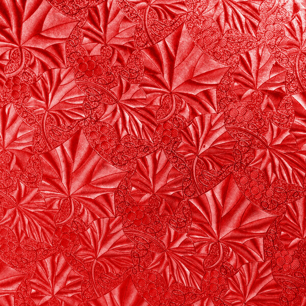 A white round cake drum with a red leather pattern.