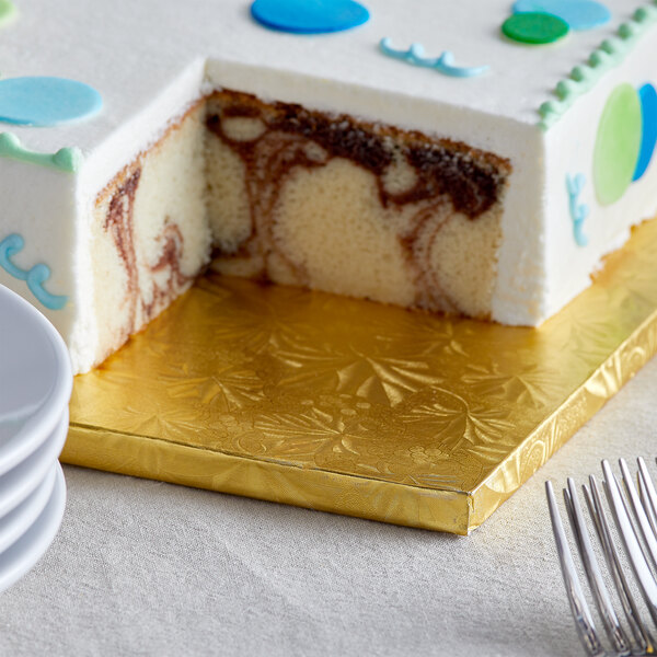 A cake on a gold Enjay fold-under cake board with a slice cut out.