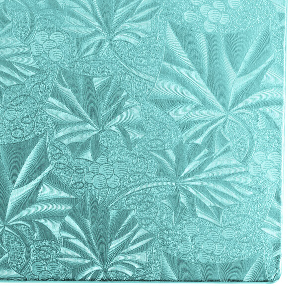 A blue Enjay cake board on a blue surface.