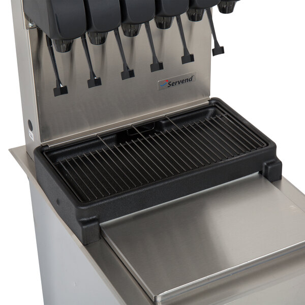A Servend soda fountain machine with six dispensers and a black tray on a stainless steel counter.