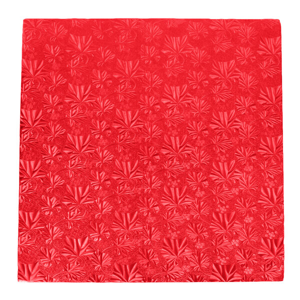 A white square cake drum with a red square pattern.