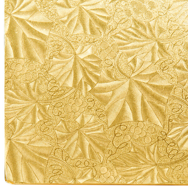 A gold patterned surface with swirls.
