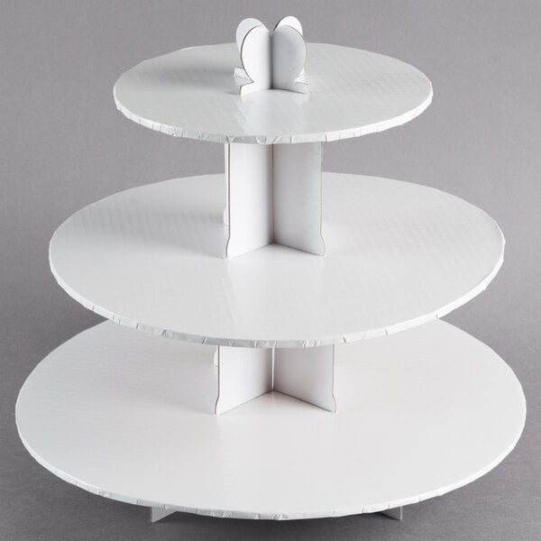 A white three tiered Enjay cupcake stand.