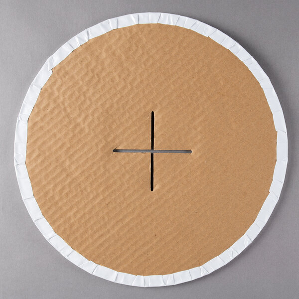 A circular cardboard cupcake stand with a cross cut out.