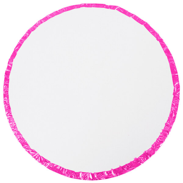 A white circular cake drum with a pink foil-wrapped edge.