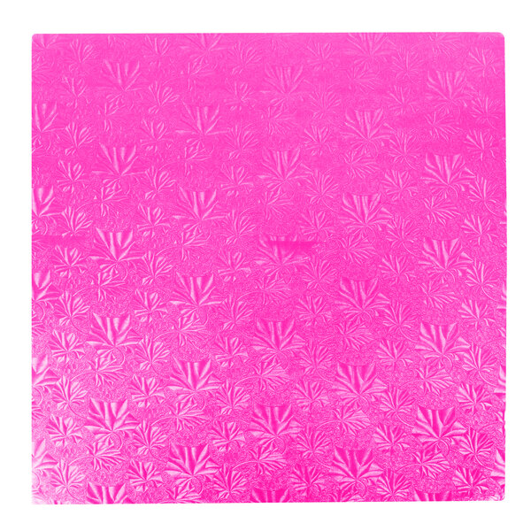 A pink square cake drum with a patterned surface.