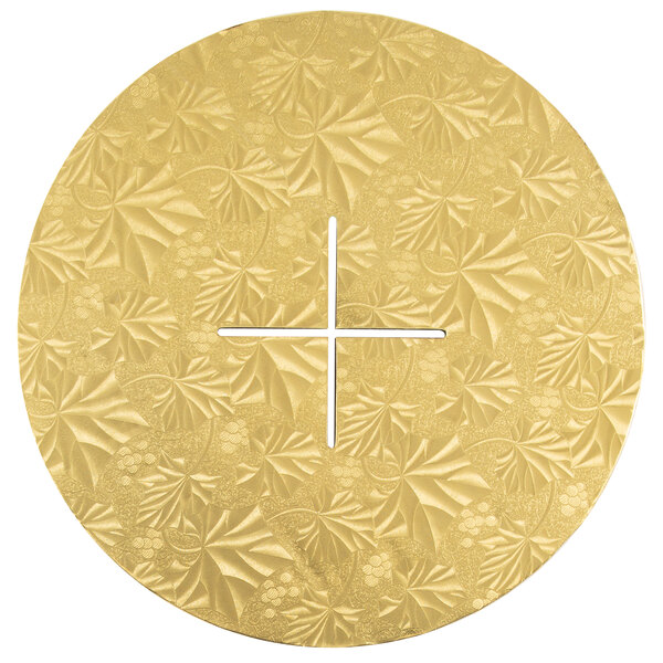 A circular gold plate with cross-shaped openings in the center.