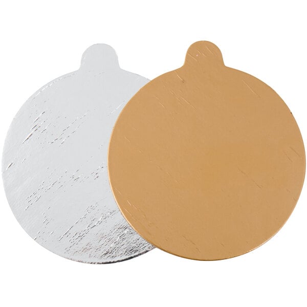 A silver and gold reversible round single serve dessert board with tabs.
